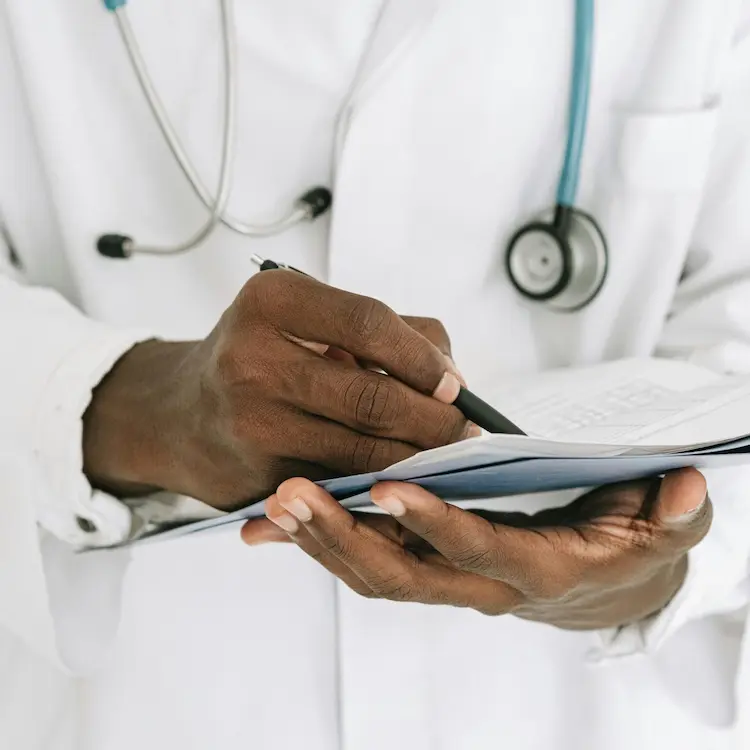 clinical-trial-physician-reviewing-patient-records-mobile2 Physician reviewing patient records for clinical trial eligibility and screening