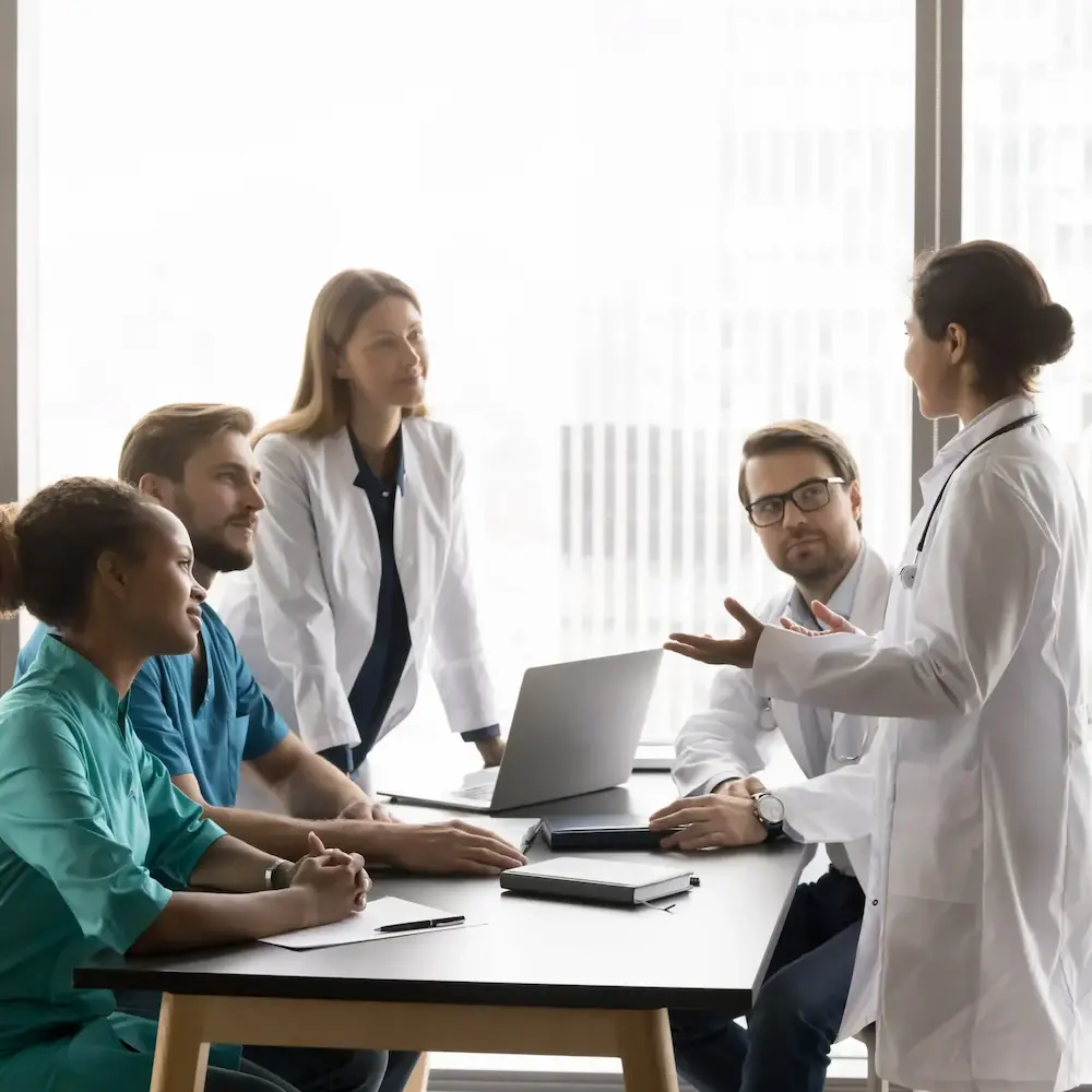 Clinical research team discussing clinical trial operations and patient enrollment strategy